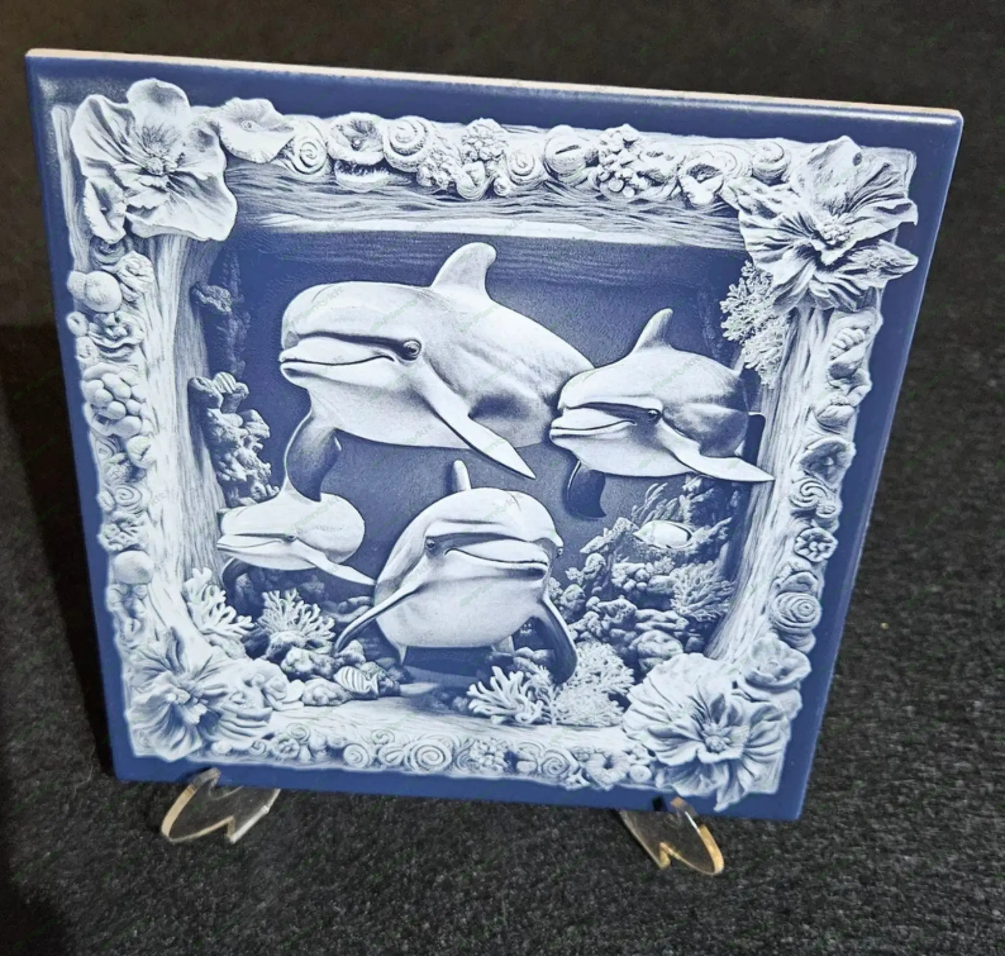 Laser engraved 3D dolphins on ceramic tile